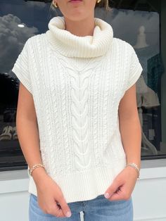 The Hatley Cable Knit Vest in Winter White is the perfect addition to any winter wardrobe. Made with a soft and cozy cable knit, this white sweater vest provides warmth and style. Pair it with your favorite long-sleeve top and jeans for a chic and comfortable winter look. Winter White Chunky Knit Turtleneck, Cozy White Pointelle Knit Top, Chic Soft Knit Sweater Vest For Winter, Cream Sweater Vest For Winter Layering, White Turtleneck Knit Top For Layering, Chic Chunky Knit Sweater Vest For Winter, White Turtleneck Sweater With Pointelle Knit, Trendy Cable Knit Sweater Vest, Chic White Sweater Vest For Layering