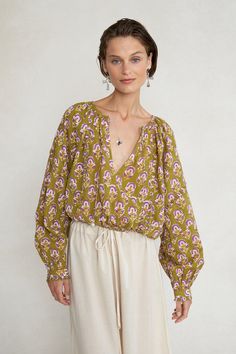 This breezy long sleeve cotton blouse features a cropped silhouette, plunging v-neckline, floral block print, and ruffle details. 100% Cotton. 24.5" Bust, 29" Sleeve, 14.5" Bottom Width, 20" Total Length. One Size: Fits sizes S-L. Machine wash cold. Made in India. Block Print Top Designs, Spring V-neck Peasant Top With Blouson Sleeves, Summer V-neck Tops With Block Print, Block Print V-neck Tops For Summer, Spring V-neck Blouse With Block Print, Green V-neck Peasant Top For Fall, Fall Green V-neck Peasant Top, V-neck Cotton Blouse With Block Print, Green Long Sleeve Peasant Blouse