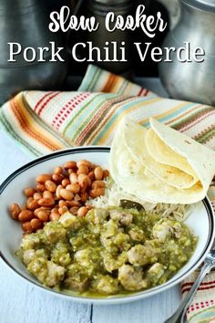 slow cooker pork chili verde with beans and tortillas in a white bowl