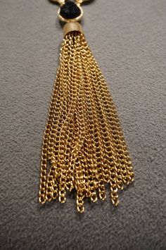 I am offering this fabulous vintage yellow gold tone necklace. This piece is truly gorgeous, and it has the following features: * beautiful vintage necklace * line link * bib style * rhinestone * tassel * glass stone * tassel measures 3 inches in length * 30 inches in length This is a fantastic and classic piece. There is tons of sparkle and shine with this piece. It will beautifully complement your upcoming fashion season. Buyer pays all shipping and handling. Gold-tone Adjustable Chain Necklace For Evening, Evening Gold-tone Adjustable Chain Necklace, Party Dangle Chain Necklace With Lobster Clasp, Gold Dangle Lariat Necklace For Parties, Gold Tassel Dangle Necklace Gift, Yellow Gold Metal Chain Necklace For Evening, Evening Gold-plated Necklace With Gold Chain, Gold Lariat Necklace With Dangle And Lobster Clasp, Gold Dangle Necklaces For Formal Occasions