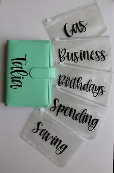 four clear bags with black writing on them and one has a notepad in the middle