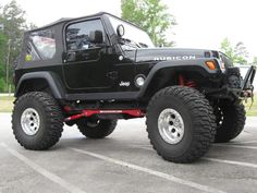 a black jeep parked in a parking lot