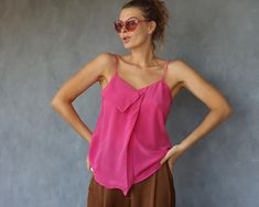 Vintage pink pure silk tiny strap blouse top. Front pleat, no lining. Material feels like pure silk. No tags. Will fit sizes XS-S best. Measured laying flat (please double for circumference): 24'' / 61 cm long 17'' / 43 cm armpit to armpit Few minor marks. Very good vintage condition. Chic Pink Silk Camisole, Pink Silk Spaghetti Strap Camisole, Pink Sleeveless Blouse Camisole For Spring, Feminine Pink Silk Camisole, Summer Silk Cami Top, Pink Silk Camisole For Summer, Pink Silk Tank Top For Spring, Silk Sleeveless Camisole For Summer, Silk Sleeveless Blouse Camisole For Summer