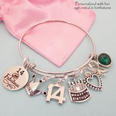 "14th Birthday Charm Bracelet, comes with all charms shown. You select which birthstone and initial you need. All of our jewelry comes beautifully and uniquely packagedready for gift-giving. We can also include a personal note The bangle is adjustable to fit most wrist sizes and is made of jewelry grade stainless steel. Stainless steel bracelets are always our choice for expandable bracelets. Stainless steel ensures your bracelet will never tarnish or lose it's color - it's also easy to care for Adjustable Charm Bracelet For Birthdays, Adjustable Round Charm Bracelet For Birthday, Handmade Round Charm Bracelet For Birthday, Pink Charm Bracelet For Birthday Gift, Birthday Round Charm Bracelet, Silver Bracelet For Birthday, May Birthstone, Silver Bracelets For Birthdays With May Birthstone, Silver Bracelets For Birthday With May Birthstone, Charm Bracelet For Birthday And Valentine's Day