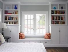 a bedroom with built in bookshelves and a bed