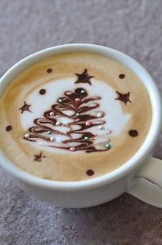 a cappuccino with a christmas tree drawn on it