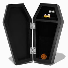 an open black box with earrings inside on a white background