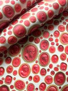 red and gold circles on white fabric with an image of a man in the center