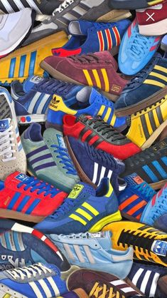 many different colored adidas sneakers are stacked on top of each other in this pile