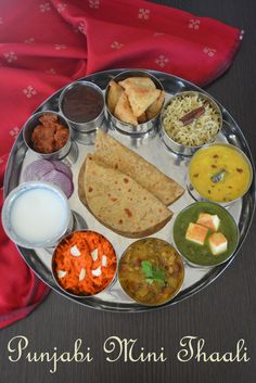 a metal plate topped with different types of food