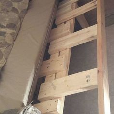 there is a ladder that has been built into the wall in this room with no walls