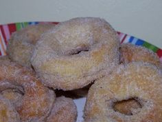 several sugared doughnuts on a colorful plate