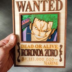 someone is holding up a wooden plaque with an image of one piece of anime character