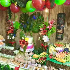 a table filled with lots of food and balloons