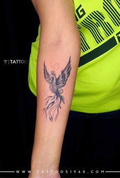 a woman's arm with a tattoo on it that has a bird in the middle