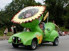 a green car with a sunflower on the back