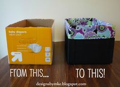 two baby diapers sitting next to each other on top of a wooden table in front of a box