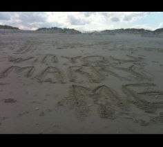 someone wrote their name in the sand at the beach