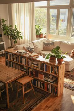 a living room filled with furniture and lots of books on top of a wooden table