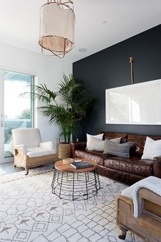 a living room filled with furniture and a chandelier hanging over the top of it