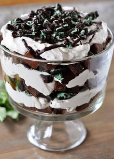 a trifle in a glass dish on a wooden table