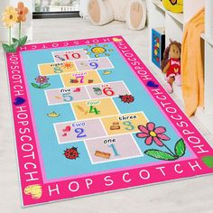 a child's rug with numbers and flowers on the floor in front of a teddy bear