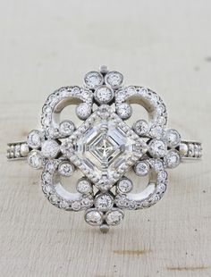 Florence has tons of vintage appeal. The band is designed with some beautiful swirls and swoops and milgrain details along each side. Her work is refined, intricate and detailed. She is set with a brilliant asscher cut diamond at her heart. She beats for you. Setting only cost: 14k Rose, White, or Yellow Gold setting $3380 18k Rose, White, or Yellow Gold setting $3500 Platinum setting $3750 #kenanddanadesign #nycjeweler #customdesign #uniqueengagementrings #customengagementrings #vintageinspired Asscher Cut Diamond Engagement Ring, Unique Engagement Rings Halo, Bezel Set Engagement Ring, Split Shank Engagement Rings, Asscher Cut Diamond, Vintage Engagement Rings Unique, Engagement Wedding Ring Sets, Round Diamond Engagement Rings, Split