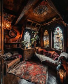 a living room filled with lots of furniture and stained glass windows in the wall behind it