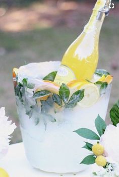 a bottle of lemonade sitting on top of a ice bucket