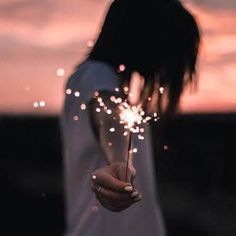 a person holding a sparkler in their hand