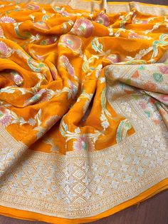 SILK MARK CERTIFIED  Stunning Turmeric Yellow Pure Khaddi Georgette Silk Saree with Water Zari and Hand-Brush Work in beautiful Floral Jaal Pattern.  Item : Saree Base Fabric : Pure Khaddi Georgette Silk  Color : Turmeric Yellow  Blouse piece : Comes with un-stitched Blouse piece. Blouse material : Pure Khaddi Georgette Silk  Work : Handloom Fall & Edging(Yes/No) : Yes Silk Mark Certificate given with the Saree(Yes/No) : Yes Disclaimer -: - Color variation is possible due to various reasons like phone or desktop setting, resolution etc. Please don't hold us responsible. Our aim is to put the exact color of the Saree. - If the Saree is Pure Silk, we will put it very clearly in our listing that it is Pure Silk. If we do not mention its Pure Silk please do not assume it is Pure Silk. When in Fitted Orange Saree For Transitional Season, Yellow Dupatta For Puja, Fitted Yellow Dupatta For Puja, Orange Katan Silk Blouse Piece, Fitted Dupatta With Motifs, Fitted Yellow Saree, Yellow Banarasi Silk Sets, Yellow Banarasi Silk Blouse Piece, Fitted Orange Saree