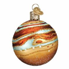 a glass ornament with an orange and blue striped ball on it's side