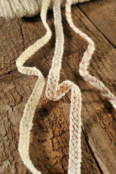 a close up of a rope on a wooden surface