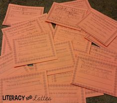 some pink papers with writing on them sitting next to each other in front of a black and white background