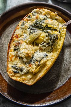 an egg dish with spinach and cheese on a plate