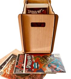 an open wooden box filled with comic books