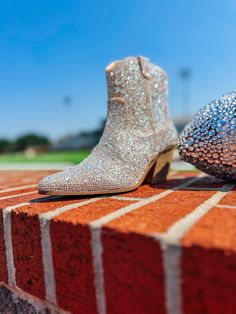 These scream Nashville!! Western-inspired ankle boot with all-over rhinestone detail. Synthetic leather / rhinestone upper. Manmade outsole. 7 in / 17.78 cm shaft height. 12 in / 30.48 cm boot opening. 2.5 in / 6.35 cm heel. Textile lining. Padded insole. Zipper closure. Fall Rhinestone Boots With Round Toe, Fall Rhinestone Round Toe Boots, Fall Boots With Rhinestones And Round Toe, Fall Rhinestone Boots, Fall Ankle Boots With Rhinestones, Fall Rhinestone Ankle Boots, Glamorous Sparkling Ankle Boots, Glamorous Boots With Rhinestone Fringe And Round Toe, Glamorous High Heel Boots With Rhinestone Fringe