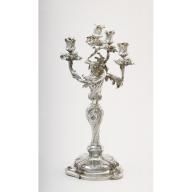 an ornate silver candelabra with five candles