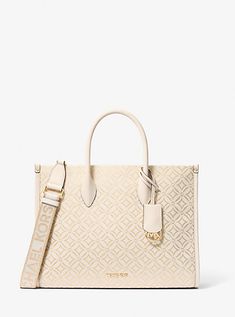 Whether you’re heading to a daytime event or simply running errands, the Mirella will meet the moment. Fit a day’s worth of essentials and a makeup bag in this tote, which can be carried by the smooth top handles or worn cross-body thanks to a removable strap. Woven with metallic threads and a kaleidoscopic take on our initials, it’s a reliable way to add polished charm to any outfit. Bag Logo, Michael Kors Outlet, Mk Bags, Metallic Bag, Bags Logo, Medium Tote, Shopper Tote, Metallic Logo, Black Tote Bag