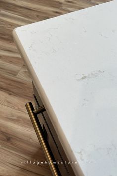 close up corner image of white marble look quartz kitchen countertops in carrara breve color. Aspen Homes, Aspen House, Home Stores, Village Home, Kitchen Surfaces