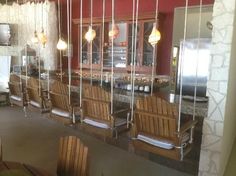 an empty restaurant with wooden chairs and lights