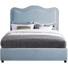 a bed with blue headboard and pillows on top of it, in front of a white background