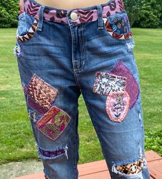 a person wearing jeans with patches on them