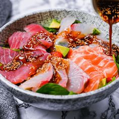 a bowl filled with different types of sushi