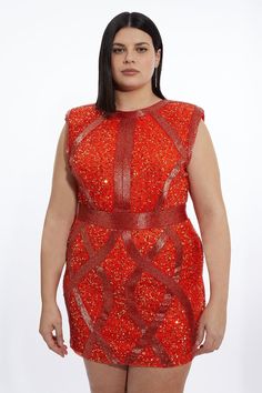 a woman wearing an orange dress with red sequins