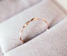 a gold ring sitting on top of a cushion