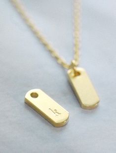 "An everyday staple, the perfect personalized initial necklace or a meaningful symbol as a daily reminder. Each individual character is hand stamped onto the bar pendant, making it truly yours! CUSTOMIZATION * 2 font styles: sans serif or serif * 2 font sizes: 2mm (both sans serif and serif) or 3mm (serif only) * 1-2 symbols maximum * indicate text and placement upon checkout * each character is hand stamped one by one and may not be perfectly aligned (though we do our best!) MATERIALS tarnish r Minimalist Hand Stamped Rectangular Pendant Necklace, Minimalist Hand Stamped Initial Necklace, Minimalist Hand Stamped Initial Necklace For Everyday, Minimalist Everyday Hand Stamped Initial Necklace, Personalized Rectangular Initial Necklace Minimalist Style, Minimalist Personalized Initial Necklace With Rectangular Pendant, Minimalist Everyday Dog Tag Charm Necklaces, Minimalist Rectangular Pendant Initial Necklace For Everyday, Minimal Bar