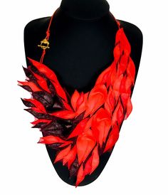 Handmade leather necklace for women. Red and black. A completely weightless necklace, unique and unrepeatable. A beautiful combination of several shades of red and black. Flowers and leaves are sewn onto 2 layers of the finest fabric. Looks great on clothes and neckline. The best choice for a summer day. Made of premium genuine Italian leather. Designed and handcrafted from LoraLeather atelier.  Necklace size without lace length: Height:  28 cm / 11 in  Width:  25 cm / 10 in All necklaces arrive Leather Necklace For Gifting, Red Leather Jewelry For Gifts, Red Leather Jewelry For Gift, Handmade Red Necklace For Evening, Red Leather Jewelry For Party, Red And Black Flowers, Handmade Leather Necklaces, Leather Fingerless Gloves, Bib Necklaces