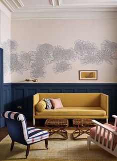 a living room filled with furniture and walls painted in shades of pink, blue and white