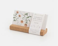 a cork business card holder with flowers on it